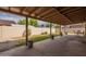Spacious backyard featuring a covered patio with a concrete surface, a small lawn, and a block wall at 1814 N 89Th Ave, Phoenix, AZ 85037