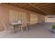 Covered patio area with concrete floors and outdoor seating at 1814 N 89Th Ave, Phoenix, AZ 85037