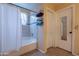 Bathroom boasts a shower over tub and a tile surround at 1814 N 89Th Ave, Phoenix, AZ 85037