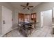 Inviting dining area with a wooden table, bench seating, and natural light from the shuttered windows creating a warm ambiance at 1814 N 89Th Ave, Phoenix, AZ 85037