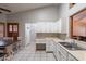 Cozy dining area with a rustic table, seating for six, and natural light pouring through the window shutters at 1814 N 89Th Ave, Phoenix, AZ 85037