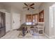 Charming dining area features a rustic wood table, comfortable seating, and stylish shutters for a cozy dining experience at 1814 N 89Th Ave, Phoenix, AZ 85037