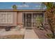 Inviting home entrance with security door, mature landscaping and decorative pottery at 1814 N 89Th Ave, Phoenix, AZ 85037