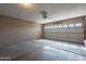 Spacious garage with a large door and concrete flooring at 1814 N 89Th Ave, Phoenix, AZ 85037