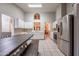 Large open kitchen boasts stainless appliances, tile floors, and lots of white cabinets at 1814 N 89Th Ave, Phoenix, AZ 85037