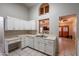 Well-lit kitchen boasts white cabinetry, ample counter space, and a convenient layout perfect for cooking and entertaining at 1814 N 89Th Ave, Phoenix, AZ 85037