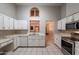 Bright kitchen features white cabinetry, a functional layout, and a seamless connection to the living spaces at 1814 N 89Th Ave, Phoenix, AZ 85037