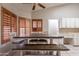 Bright eat-in kitchen area with custom wood shutters and built-in white cabinetry at 1814 N 89Th Ave, Phoenix, AZ 85037