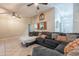 Inviting living room showcases a sectional sofa, tile floors, and charming window accents for a welcoming ambiance at 1814 N 89Th Ave, Phoenix, AZ 85037
