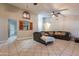 Comfortable living room with a large sectional sofa, tile flooring, and unique architectural details at 1814 N 89Th Ave, Phoenix, AZ 85037