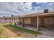 Covered back patio with space for entertaining and a grassy area to relax and enjoy the weather at 1814 N 89Th Ave, Phoenix, AZ 85037