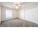 Bright bedroom with a ceiling fan, closet, and a window overlooking the yard at 1820 E Morten Ave # 119, Phoenix, AZ 85020