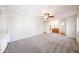 Spacious bedroom with neutral carpet, ceiling fan, and adjacent bathroom at 1820 E Morten Ave # 119, Phoenix, AZ 85020