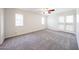 Bedroom with neutral carpet, a ceiling fan, and a large window for natural light at 1820 E Morten Ave # 119, Phoenix, AZ 85020