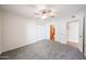 Spacious bedroom with plush carpeting, a ceiling fan, and ample closet space at 1820 E Morten Ave # 119, Phoenix, AZ 85020