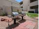 Community grills surrounded by green landscaping and trees in the neighborhood at 1820 E Morten Ave # 119, Phoenix, AZ 85020