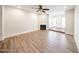 Bright living room with hardwood floors, a fireplace, and a view of the entryway at 1820 E Morten Ave # 119, Phoenix, AZ 85020