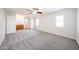 Large main bedroom with carpet, ceiling fan, ensuite bathroom, and natural light at 1820 E Morten Ave # 119, Phoenix, AZ 85020
