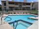 Community pool and spa with lounge chairs and a serene setting at 1820 E Morten Ave # 119, Phoenix, AZ 85020