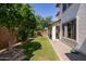 Lush backyard featuring mature trees, a well-manicured lawn, and a covered patio at 18809 E Seagull Dr, Queen Creek, AZ 85142