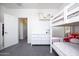 Well-lit bedroom boasts bunk beds, a white dresser, and access to an ensuite bathroom at 18809 E Seagull Dr, Queen Creek, AZ 85142