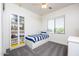 Cozy bedroom with a single bed, display shelves, and ample natural light at 18809 E Seagull Dr, Queen Creek, AZ 85142