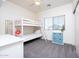 Bright bedroom featuring bunk beds, a ceiling fan, and a window with blinds at 18809 E Seagull Dr, Queen Creek, AZ 85142