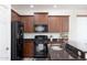 Close-up of kitchen appliances, including a black gas range and stainless steel sink at 18809 E Seagull Dr, Queen Creek, AZ 85142