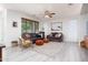 Open-concept living room with hardwood floors, modern decor, and natural light at 18809 E Seagull Dr, Queen Creek, AZ 85142