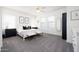 Spacious main bedroom with a white bed, stylish decor, and plenty of natural light at 18809 E Seagull Dr, Queen Creek, AZ 85142
