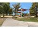 Community playground with slide and covered play area surrounded by green space at 18809 E Seagull Dr, Queen Creek, AZ 85142