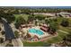 Aerial view of community pool with covered seating, mature landscaping, and neighboring green space at 18809 E Seagull Dr, Queen Creek, AZ 85142