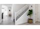 Bright staircase features white railing and a decorative potted plant at 18809 E Seagull Dr, Queen Creek, AZ 85142