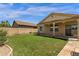 Lush green backyard features a covered patio and block wall fence, creating a private outdoor space at 1960 S Falcon Dr, Gilbert, AZ 85295