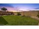 Expansive backyard featuring a large grass area, patio set, and stucco wall, perfect for outdoor entertaining at 1960 S Falcon Dr, Gilbert, AZ 85295