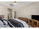 Spacious bedroom features neutral walls, a ceiling fan, and two wooden dressers for ample storage at 1960 S Falcon Dr, Gilbert, AZ 85295