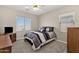 Cozy bedroom features neutral walls, carpet flooring, and a bed with a decorative striped comforter and pillows at 1960 S Falcon Dr, Gilbert, AZ 85295