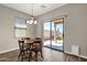 Bright dining area featuring tile flooring, a wood table with chairs and a sliding door to backyard at 1960 S Falcon Dr, Gilbert, AZ 85295