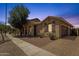 Beautiful single-story home boasts a well-manicured lawn, brick driveway, and attached two-car garage at 1960 S Falcon Dr, Gilbert, AZ 85295