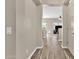 Hallway with wood-look tile floors leading to a bright living space at 1960 S Falcon Dr, Gilbert, AZ 85295