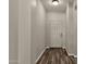 Narrow hallway with tile flooring leads to a white door at 1960 S Falcon Dr, Gilbert, AZ 85295