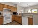 Functional kitchen featuring essential appliances and natural wood cabinets at 1960 S Falcon Dr, Gilbert, AZ 85295