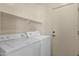 Functional laundry room with a washer, a dryer, and a door leading to other parts of the home at 1960 S Falcon Dr, Gilbert, AZ 85295