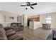 Open-concept living room with wood flooring, ceiling fan and seamless flow to the kitchen and dining area at 1960 S Falcon Dr, Gilbert, AZ 85295