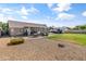 Large backyard with gravel, grass, covered patio, and space for parking vehicles or RV at 20464 E Bronco Dr, Queen Creek, AZ 85142