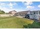 Spacious lawn in backyard with covered patio, utility vehicles, and partial fence at 20464 E Bronco Dr, Queen Creek, AZ 85142