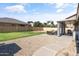 Backyard features a lush lawn, gravel area, covered patio with seating and BBQ at 20464 E Bronco Dr, Queen Creek, AZ 85142