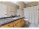 Well-lit bathroom featuring a granite countertop and shower with decorative shower curtain at 20464 E Bronco Dr, Queen Creek, AZ 85142