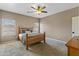 Cozy bedroom with carpet, a ceiling fan, a wooden bed frame and window views at 20464 E Bronco Dr, Queen Creek, AZ 85142
