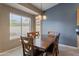 Charming dining room featuring a wooden table set, natural light, and tile flooring at 20464 E Bronco Dr, Queen Creek, AZ 85142